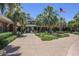 Beautiful club entrance featuring palm trees, manicured lawns, and an inviting pathway leading to the building at 17833 W Verdin Rd, Goodyear, AZ 85338