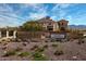 Elegant club entrance with stone signage, landscaped grounds, and a welcoming architectural design at 17833 W Verdin Rd, Goodyear, AZ 85338