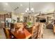 Dining area featuring a large table, stylish lighting, and open to kitchen and living room at 17833 W Verdin Rd, Goodyear, AZ 85338