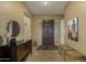 Inviting entryway featuring tile flooring, decorative furnishings, and a stylish front door at 17833 W Verdin Rd, Goodyear, AZ 85338