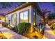 A home's desert landscape is highlighted by a stone path, mature cacti, and other greenery around the building at 17833 W Verdin Rd, Goodyear, AZ 85338