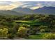 Scenic golf course view with lush greenery and mountain backdrop creating a serene and picturesque setting at 17833 W Verdin Rd, Goodyear, AZ 85338