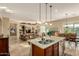 Spacious kitchen featuring granite countertops, stainless steel appliances, and a view into the living room at 17833 W Verdin Rd, Goodyear, AZ 85338