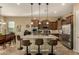 Modern kitchen island with granite countertops, seating, and stainless steel appliances at 17833 W Verdin Rd, Goodyear, AZ 85338