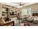 Cozy living room with stone accent wall and shelving, comfortable seating, and natural light at 17833 W Verdin Rd, Goodyear, AZ 85338