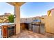 Outdoor kitchen space with built-in barbecue, counter space, cooler, and ample storage for an outdoor chef at 17833 W Verdin Rd, Goodyear, AZ 85338