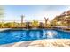 Sparkling pool with rock waterfall feature and desert landscape at 17833 W Verdin Rd, Goodyear, AZ 85338