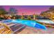 Beautiful pool with a spa, fire pit, desert landscaping, and lounge chairs at 17833 W Verdin Rd, Goodyear, AZ 85338