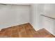 Large walk-in closet with double hanging rods and tile floor at 18206 N 86Th Ln, Peoria, AZ 85382