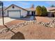 House exterior showcasing a well-maintained front yard and a two-car garage at 18206 N 86Th Ln, Peoria, AZ 85382