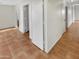 Clean hallway with light walls and terracotta tile floors at 18206 N 86Th Ln, Peoria, AZ 85382