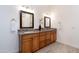 Bathroom featuring double sinks, granite countertop, and wood-look tile flooring at 18206 W Solano Ct, Litchfield Park, AZ 85340