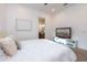 Bright bedroom features a white comforter, wall art, and a TV on a stand at 18206 W Solano Ct, Litchfield Park, AZ 85340