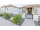 Inviting front entry with a stone archway, gated courtyard, and paver walkway at 18206 W Solano Ct, Litchfield Park, AZ 85340