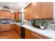 Modern kitchen featuring wood cabinets, stone backsplash, and white countertops at 18206 W Solano Ct, Litchfield Park, AZ 85340