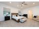 Spacious main bedroom suite with ceiling fan, a cozy sitting area, and an attached baby room at 18206 W Solano Ct, Litchfield Park, AZ 85340