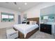 Bright main bedroom boasts a large window, a wooden headboard, and neutral accents at 18206 W Solano Ct, Litchfield Park, AZ 85340