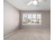 Bright bedroom featuring large windows and ceiling fan at 18212 N 136Th Ave, Sun City West, AZ 85375