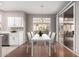 Virtually staged dining area with white table and chairs at 18212 N 136Th Ave, Sun City West, AZ 85375