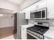 Kitchen with stainless steel appliances and white cabinets at 18212 N 136Th Ave, Sun City West, AZ 85375