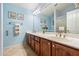 Clean bathroom with light blue walls, double sinks, and a large mirror at 19275 N 88Th Way, Scottsdale, AZ 85255