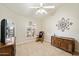 Spacious bedroom with a ceiling fan, large window, and built-in wooden cabinet at 19275 N 88Th Way, Scottsdale, AZ 85255