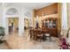 Elegant dining room with a large wooden table and access to the kitchen at 19275 N 88Th Way, Scottsdale, AZ 85255