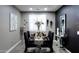 Modern dining room with black chairs and glass table at 20509 N Enchantment Pass, Maricopa, AZ 85138