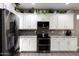 Modern kitchen with granite countertops, stainless steel appliances, and white cabinets at 20509 N Enchantment Pass, Maricopa, AZ 85138