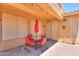 Covered patio with seating area, umbrella, and access to the interior at 20509 N Enchantment Pass, Maricopa, AZ 85138