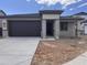 Charming single-story home featuring a two-car garage and a welcoming front entry with stone-accented columns at 20634 N 226Th Dr, Surprise, AZ 85387