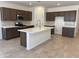 Bright kitchen with stainless steel appliances, white countertops, and central island at 20634 N 226Th Dr, Surprise, AZ 85387