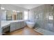 Modern bathroom with a freestanding tub and double vanity at 2142 W Enfield Way, Chandler, AZ 85286