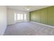 Bedroom with bay window, ceiling fan, and green accent wall at 2142 W Enfield Way, Chandler, AZ 85286