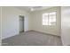 Well-lit bedroom with neutral carpeting and a large window at 2142 W Enfield Way, Chandler, AZ 85286