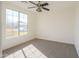 Well-lit bedroom featuring a ceiling fan and carpet flooring at 2142 W Enfield Way, Chandler, AZ 85286