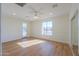 Bright bedroom with wood-look floors and sliding mirrored closet doors at 2142 W Enfield Way, Chandler, AZ 85286