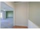 Hallway with wood-look floors and view into bedroom with green accent wall at 2142 W Enfield Way, Chandler, AZ 85286