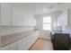 Laundry room with white cabinets and ample counter space at 2142 W Enfield Way, Chandler, AZ 85286