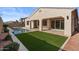 Home exterior showcasing a private pool and grassy backyard at 22847 E Sonoqui Blvd, Queen Creek, AZ 85142