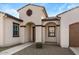 Home's entrance with arched entryway and brown door at 22847 E Sonoqui Blvd, Queen Creek, AZ 85142