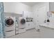 Bright laundry room with washer, dryer, and ample storage at 22847 E Sonoqui Blvd, Queen Creek, AZ 85142