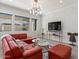 Living room with red sectional sofa and accent chairs at 22847 E Sonoqui Blvd, Queen Creek, AZ 85142