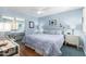 Bright bedroom with mirrored closet doors and wood floors at 24502 S Starcrest Dr, Sun Lakes, AZ 85248