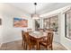 Bright dining room with a wooden table and access to the back patio at 24502 S Starcrest Dr, Sun Lakes, AZ 85248