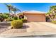 Single-story home with a two-car garage and landscaped front yard at 24502 S Starcrest Dr, Sun Lakes, AZ 85248