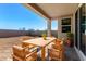 Covered patio with wooden table and chairs, ready for use at 25233 N 131St Dr, Peoria, AZ 85383