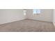 Simple carpeted bedroom with neutral walls and window at 25233 N 131St Dr, Peoria, AZ 85383