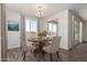 Dining area with wood table and chairs, plus access to patio at 25233 N 131St Dr, Peoria, AZ 85383