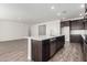 Modern kitchen with dark cabinetry and a large island at 25233 N 131St Dr, Peoria, AZ 85383